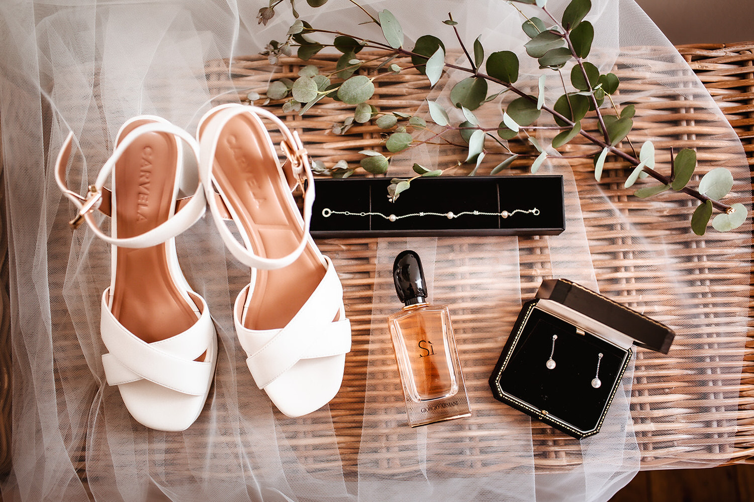 photo of bride's wedding shoes, perfume, earrings and veil