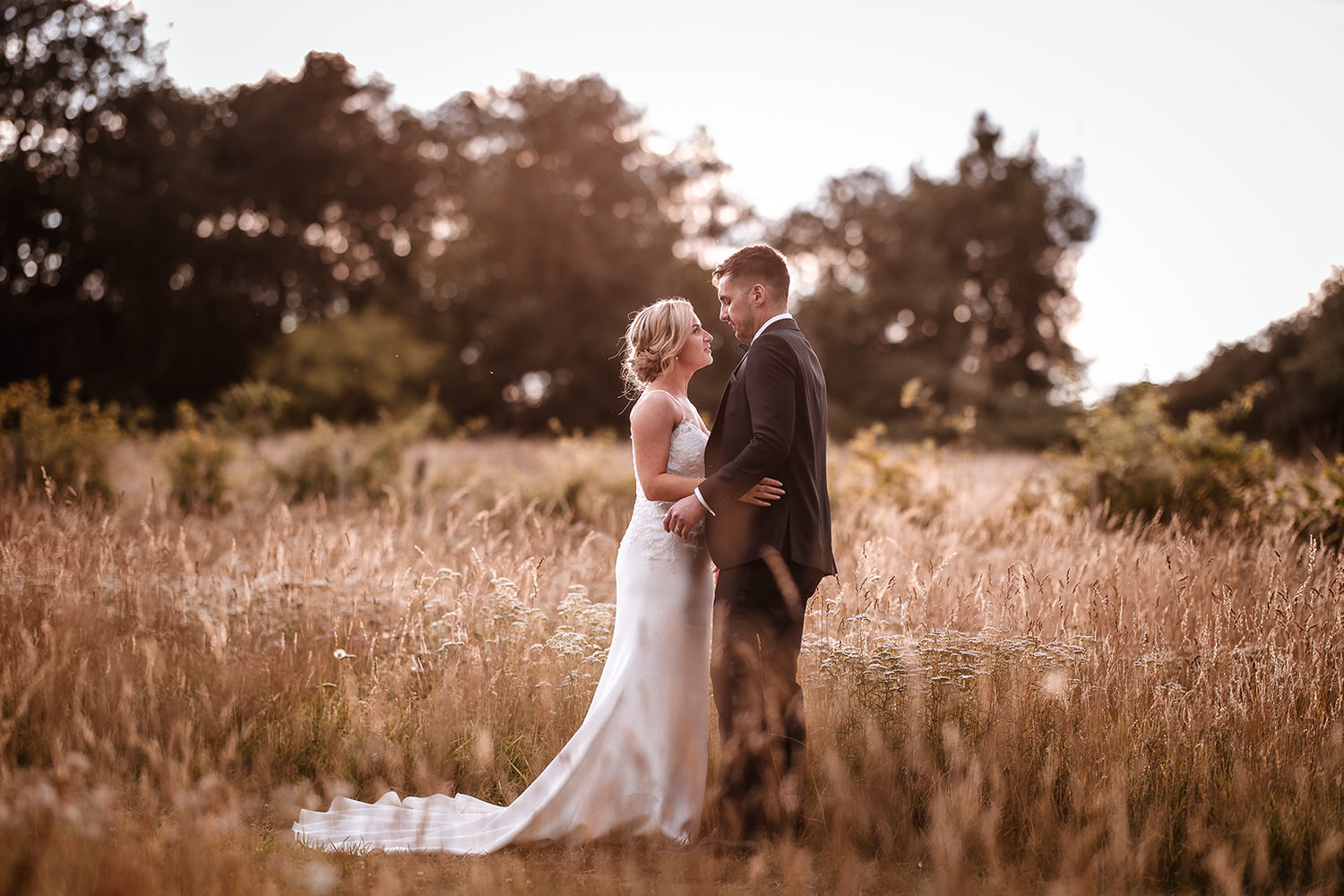 Sunset wedding photo of bride and groom in the field at Gate Street Barn in Surrey