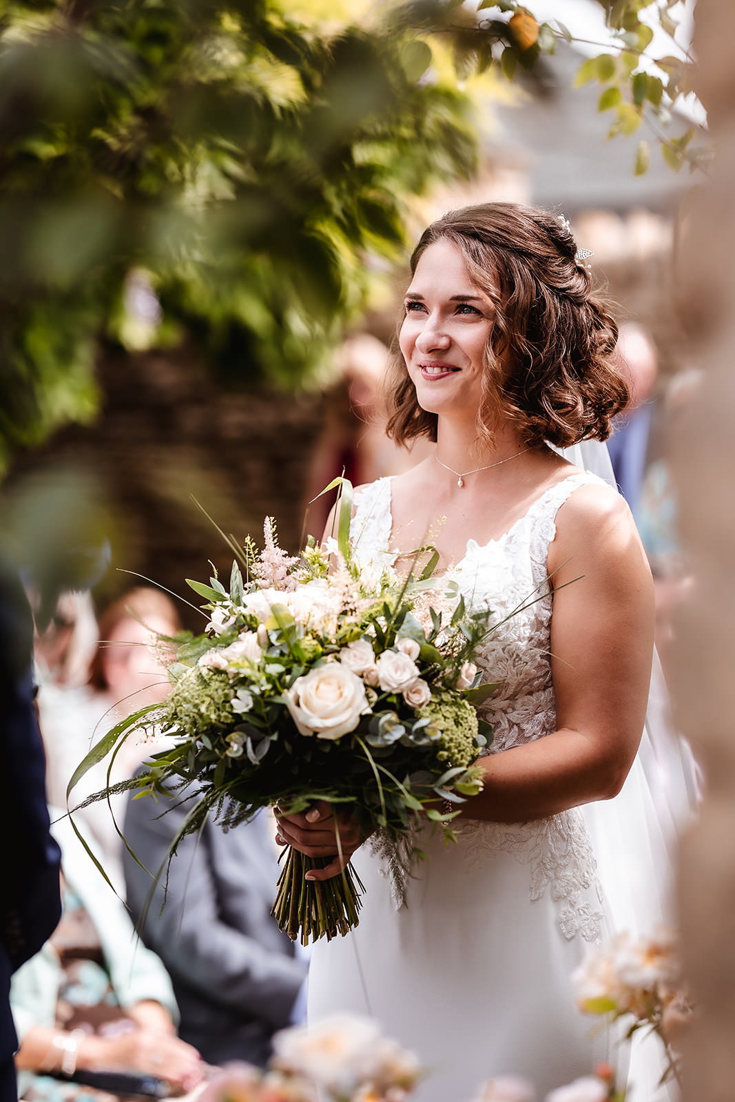 summer photo of bride holding her flowers