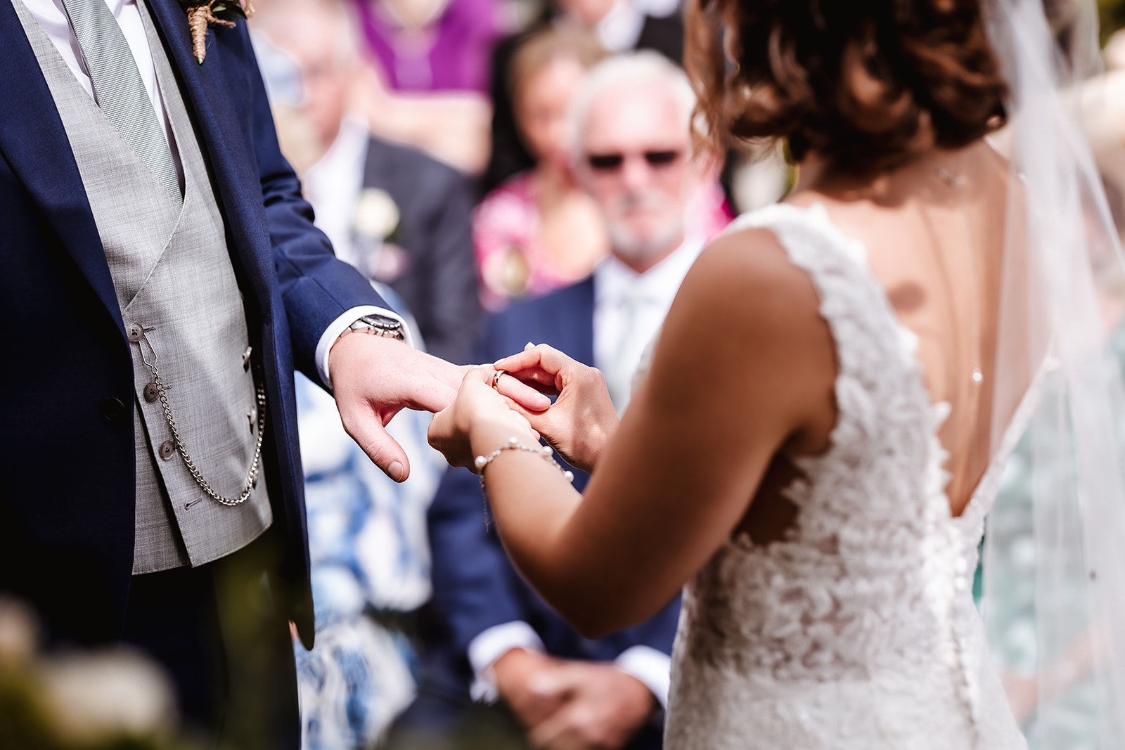 Cotswold wedding photography. Exchanging the rings during the ceremony