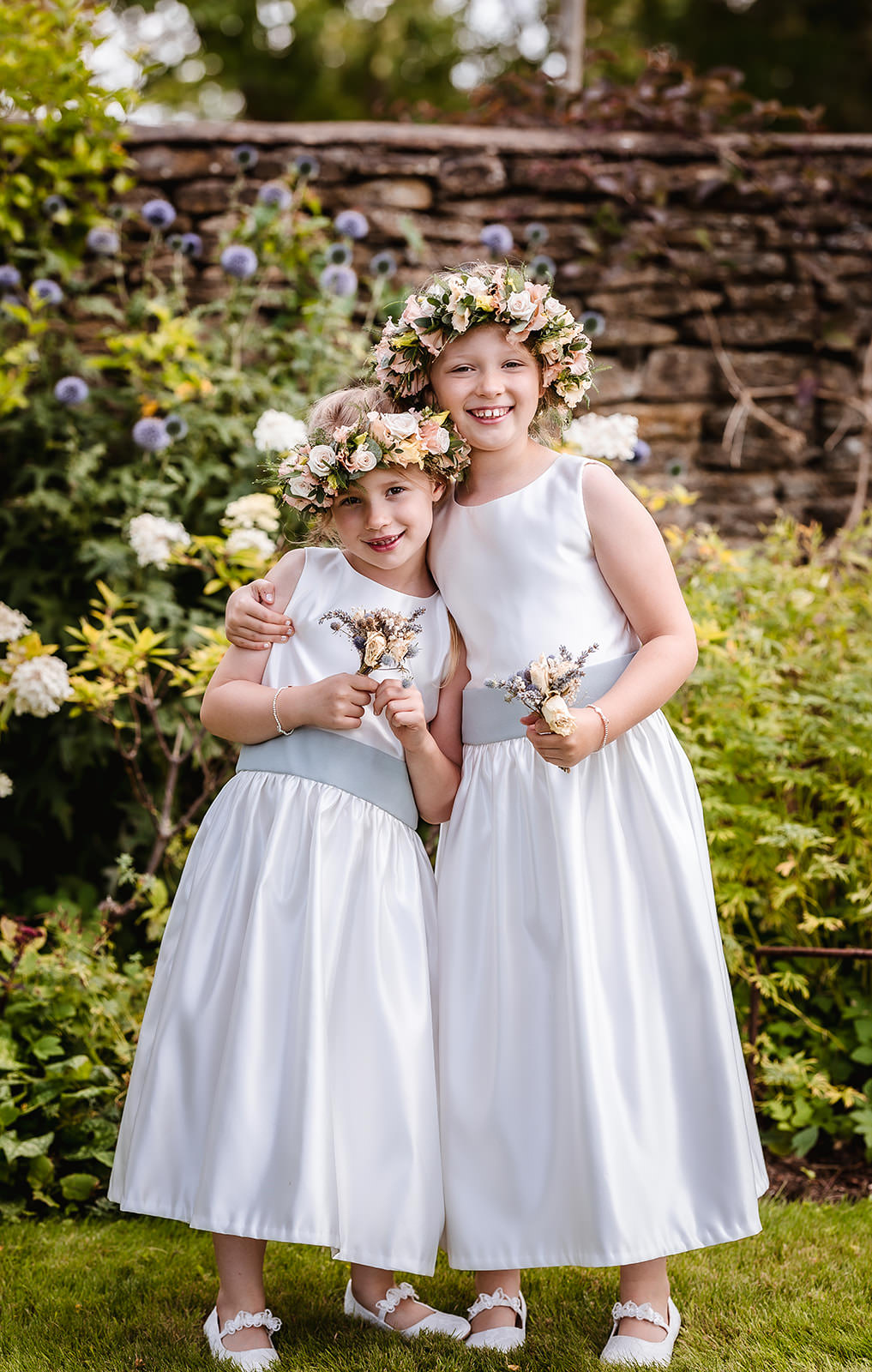 flower girls in white satin dress with flower hair band