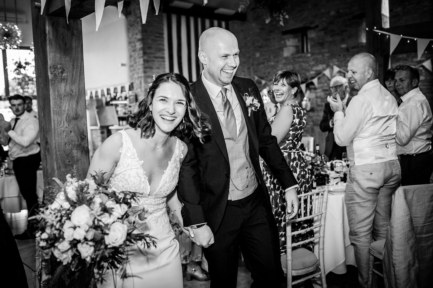 bride and groom entering the reception room at Winkworth Farm