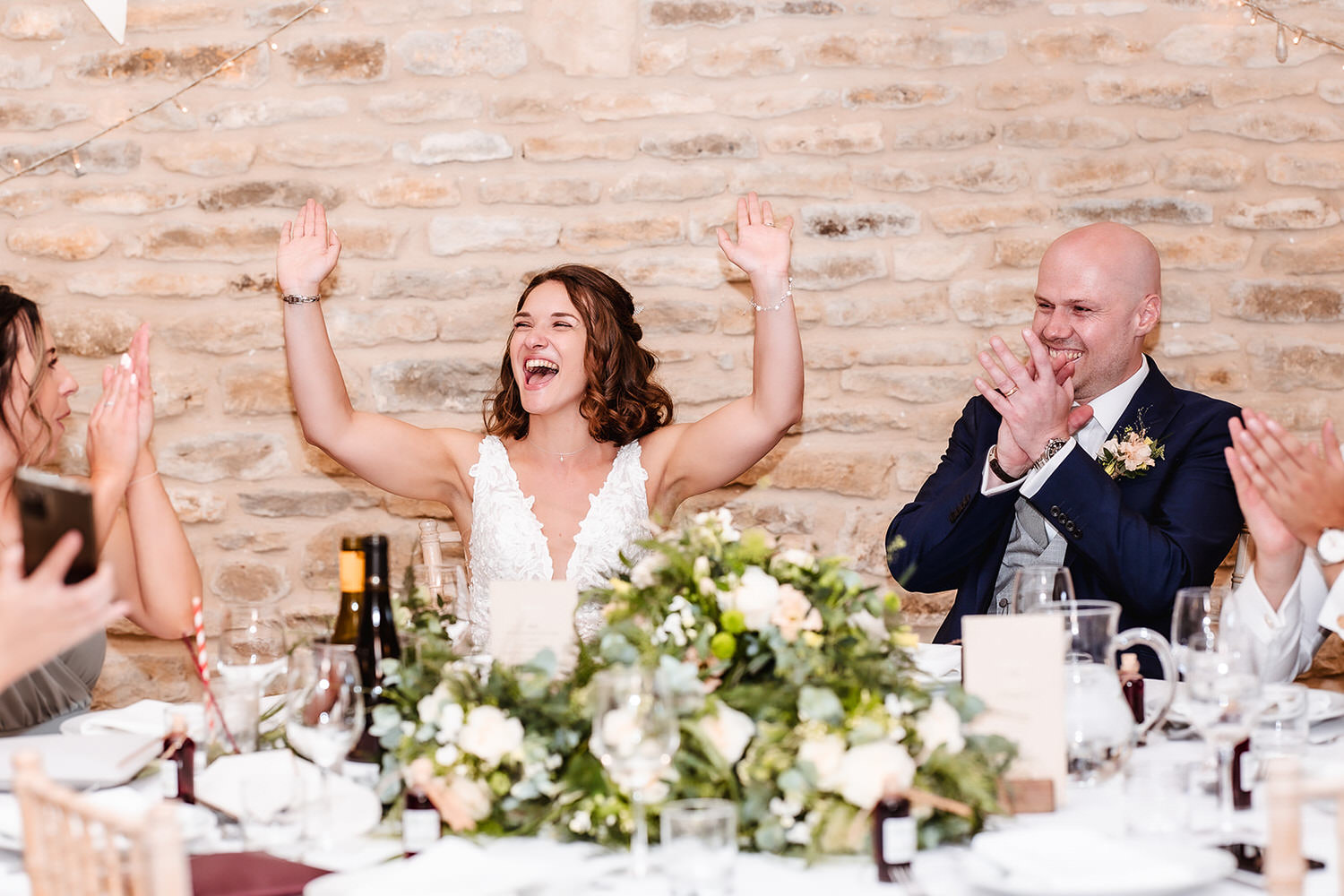 candid and fun photo of bride and groom during the speech at indoor wedding venue at Wilthire