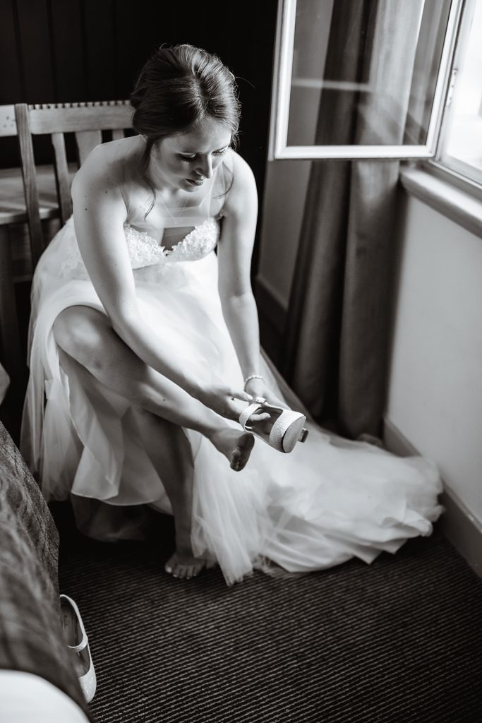 bride is putting her shoes on at The Swan Hotel Alton