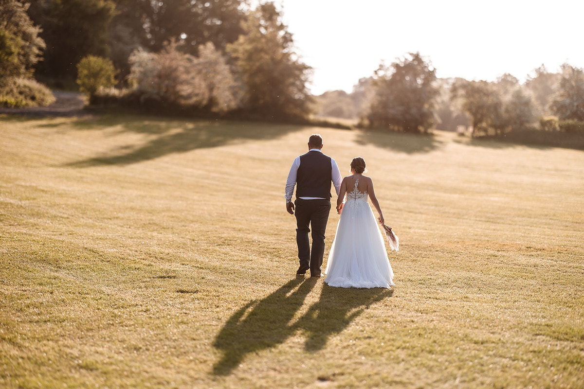 Natural, relaxed and romantic wedding photo of bride and groom during the sunset in Alton Hampshire