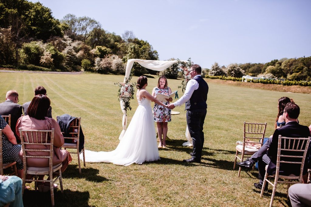 Hampshire country outdoor wedding ceremony in the field. Hampshire wedding photogapher