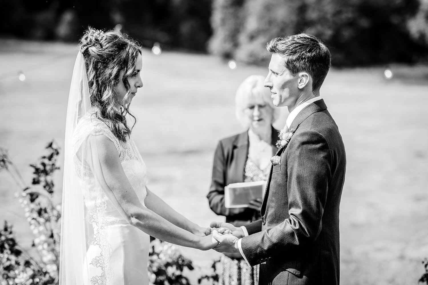 black and white photo of bride and groom during the outdoor ceremony.