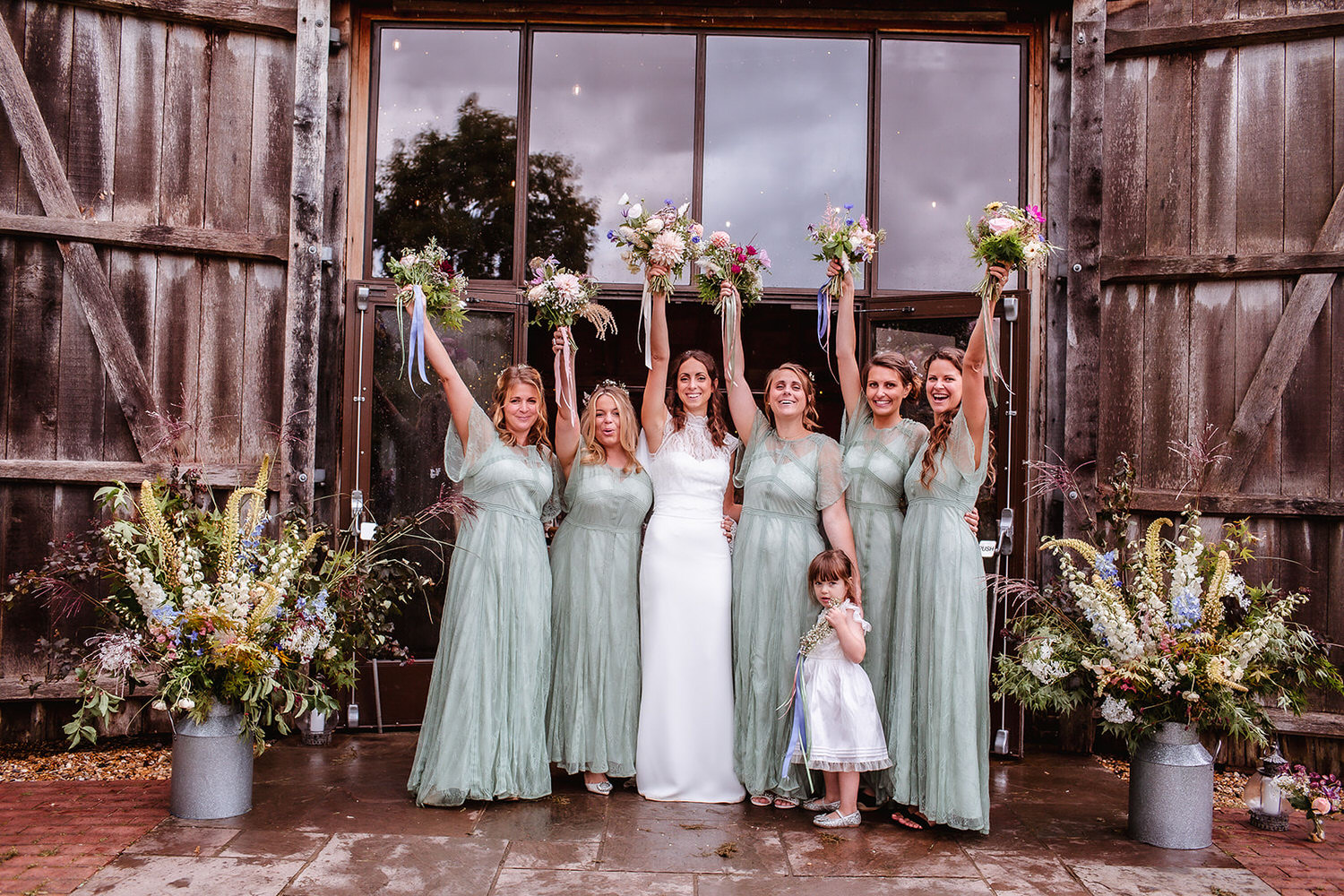 group photo of bride with her bridesmaid outside of the barn in Hampshire