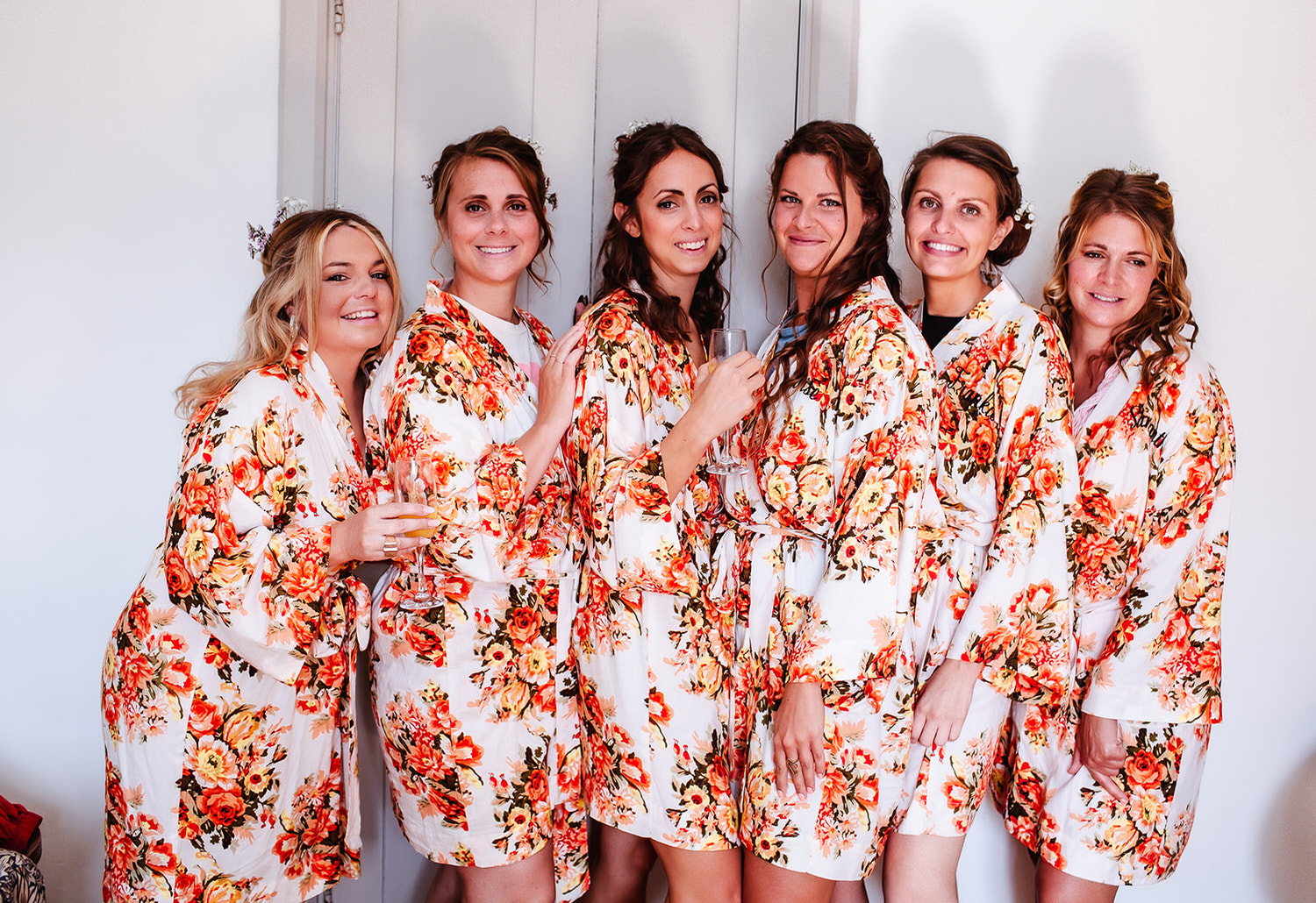 bride with bridesmaids wearing wedding satin flower robes