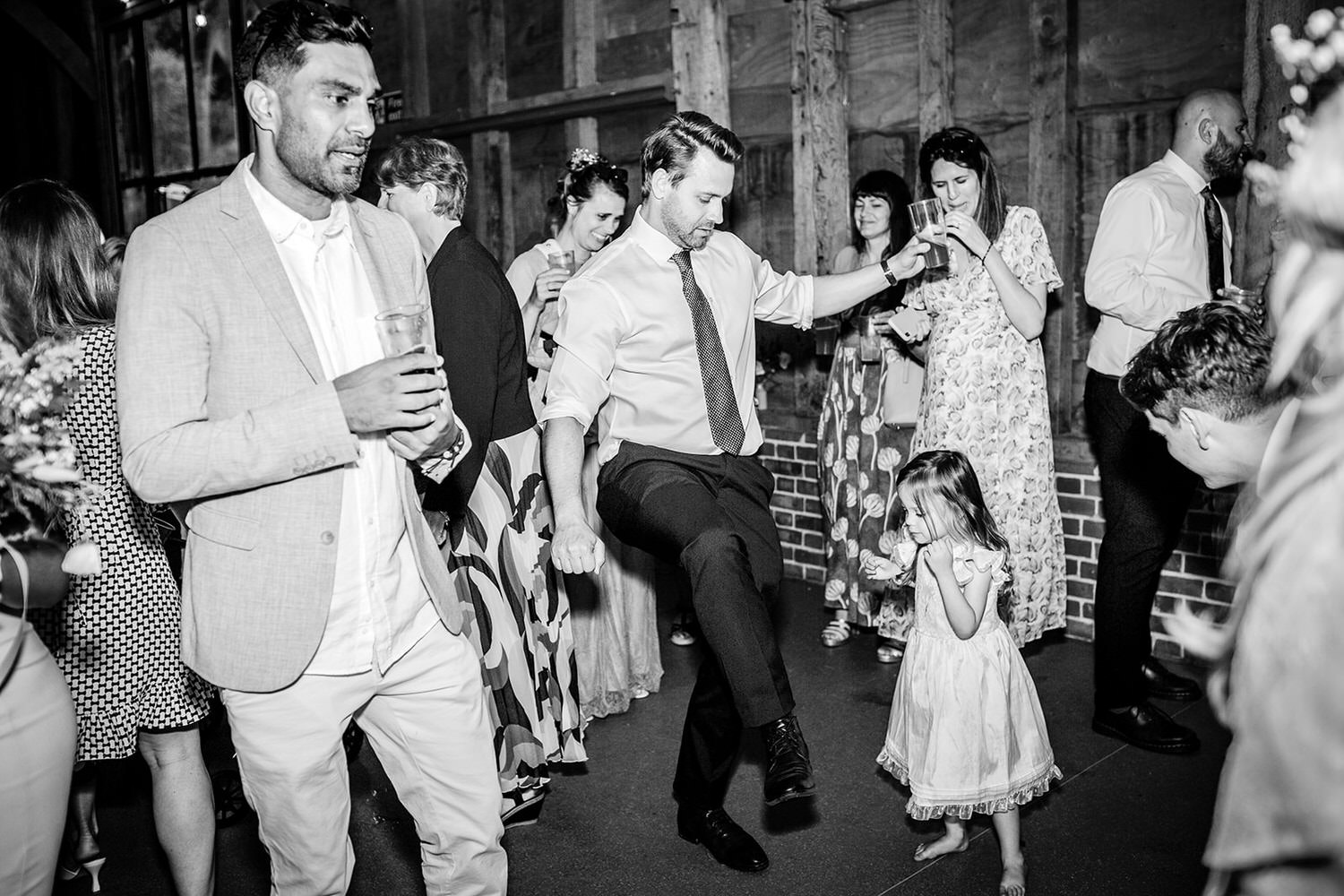 wedding guests on the dance floor at rustic barn Hampshire wedding venue