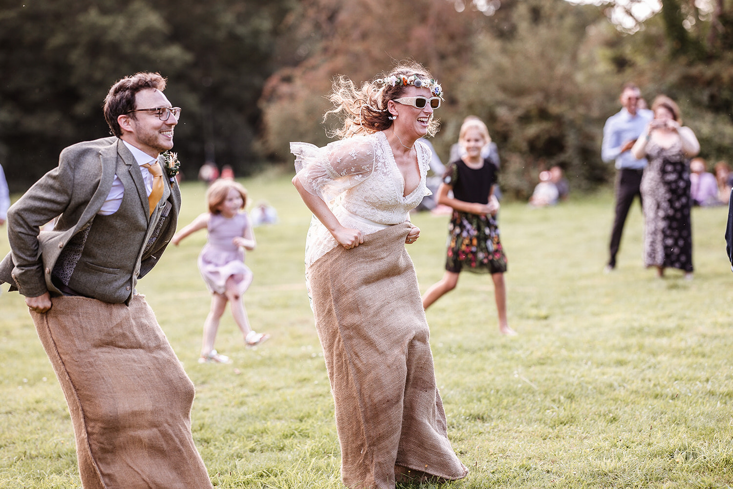 bride jumping in the race bag in the park