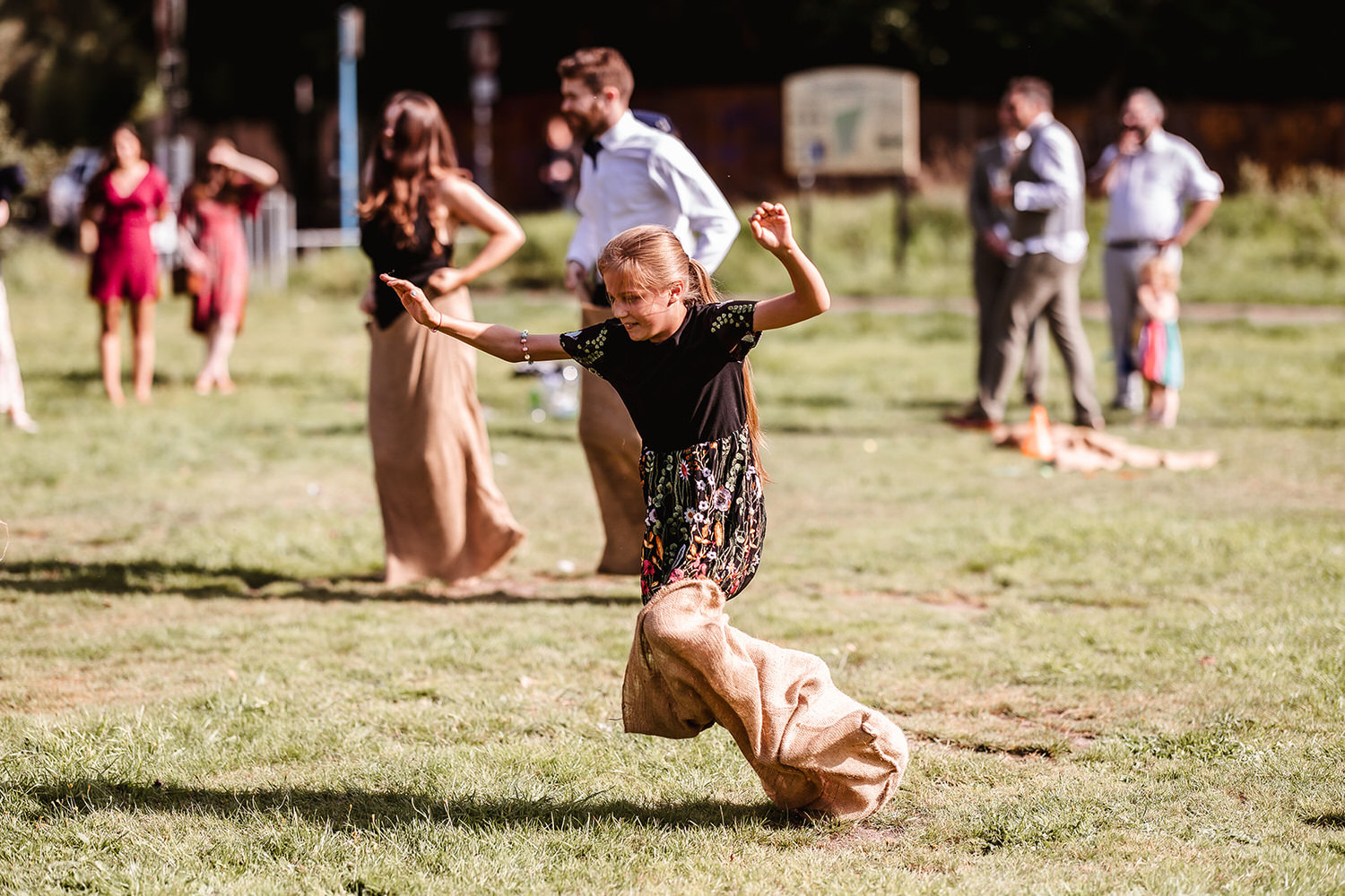 jumping in the bag in the park at the wedding