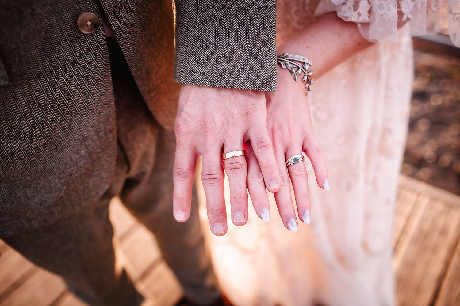 wedding photo of bride and groom's rings on their hand