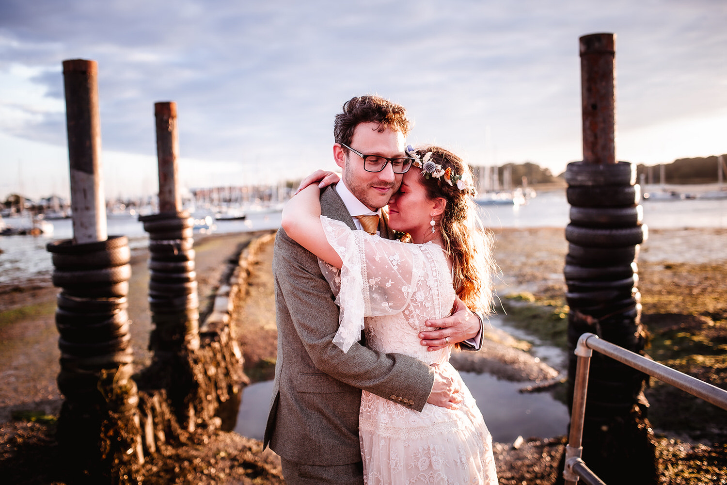 sunset photo of bride and groom holding hands and looking at each other at Warsash Harbour