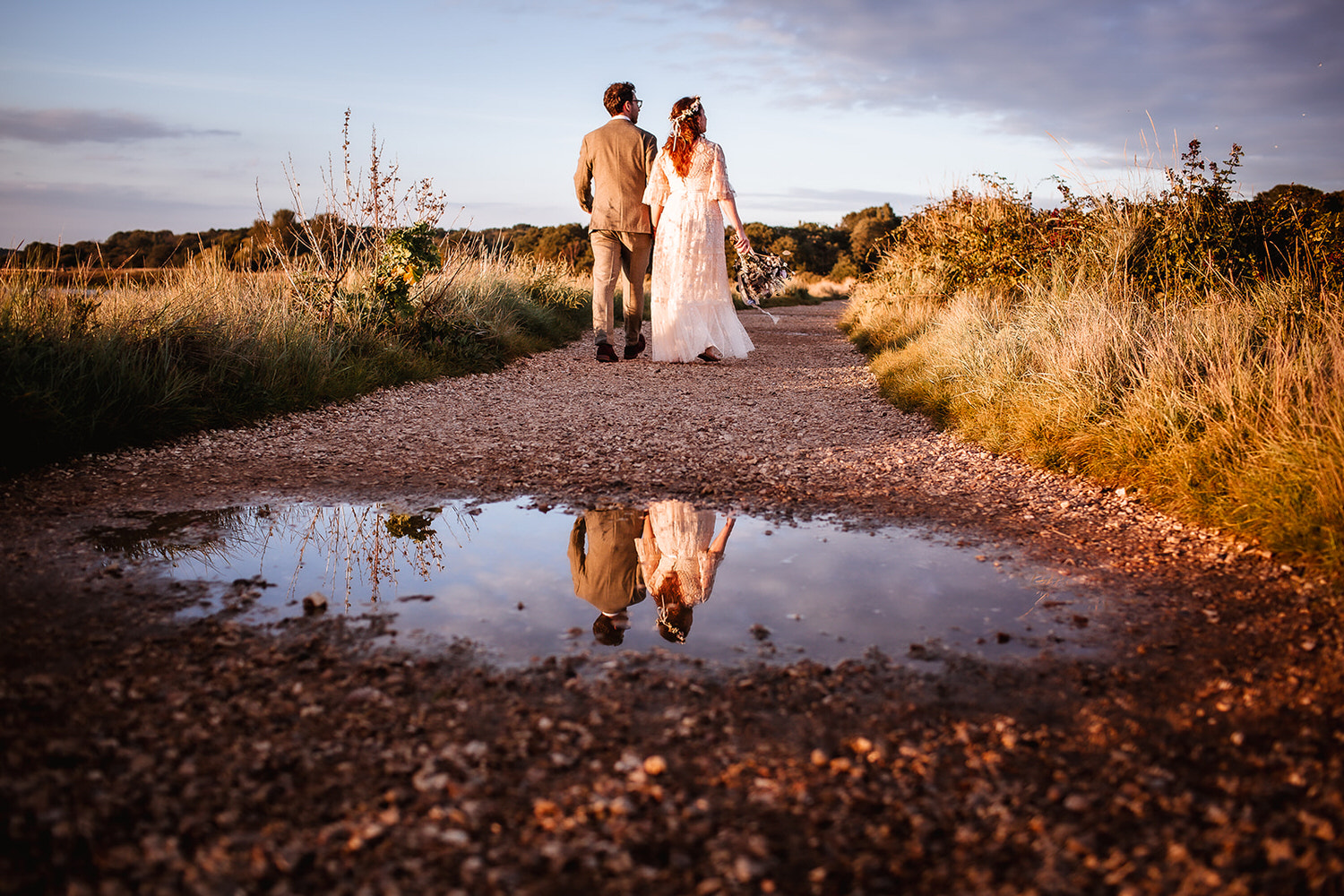 artistic and creative photo of reflection of wedding couple in the paddle