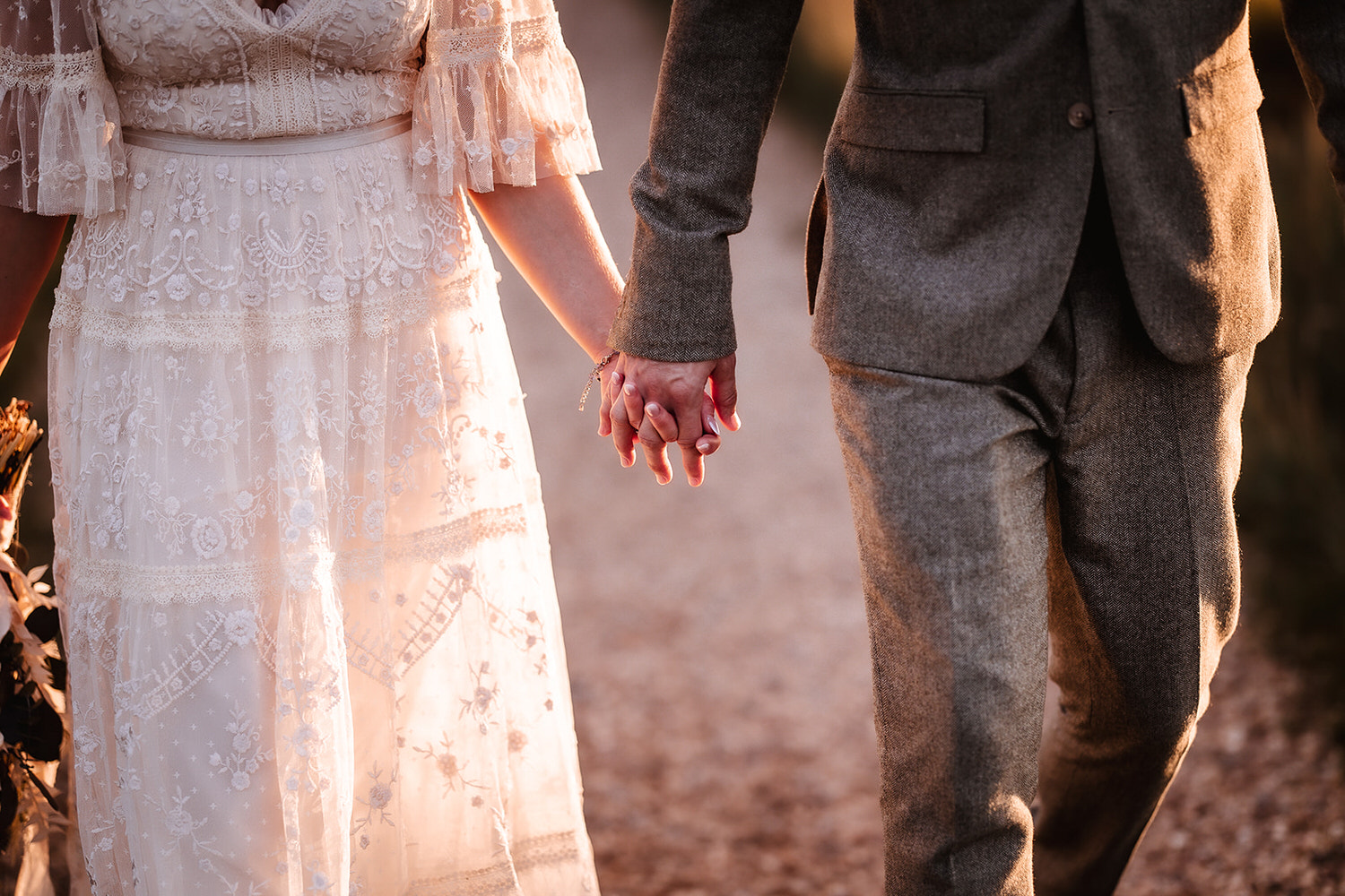 bride and groom holding hands