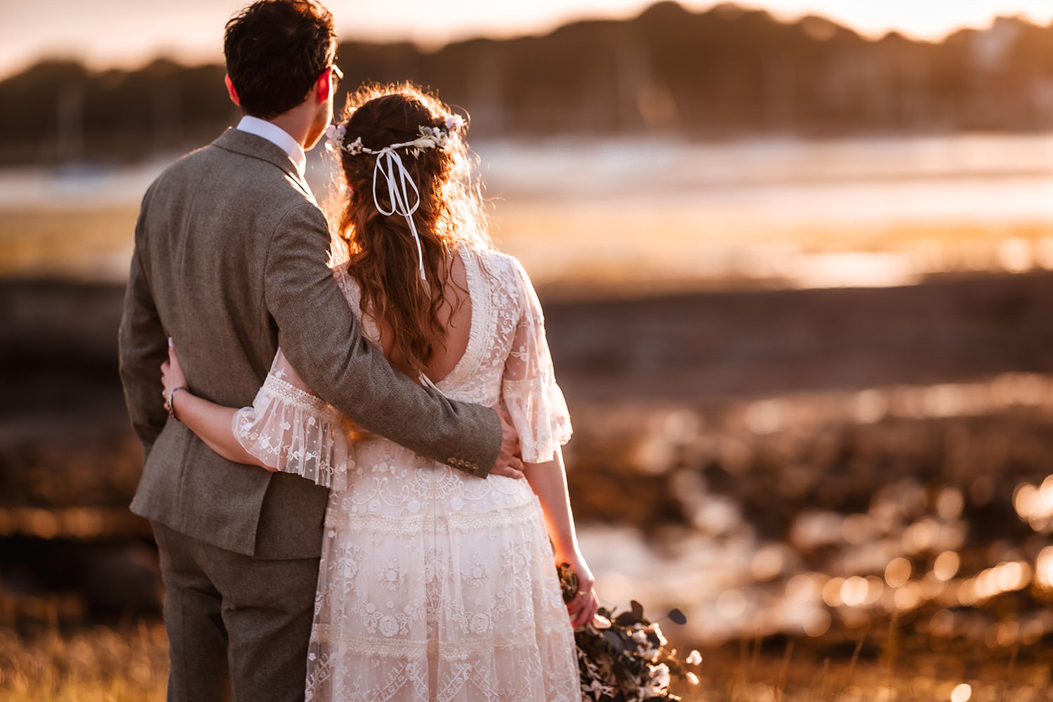 sunset photo of bride and groom looking at the sea in Southampton