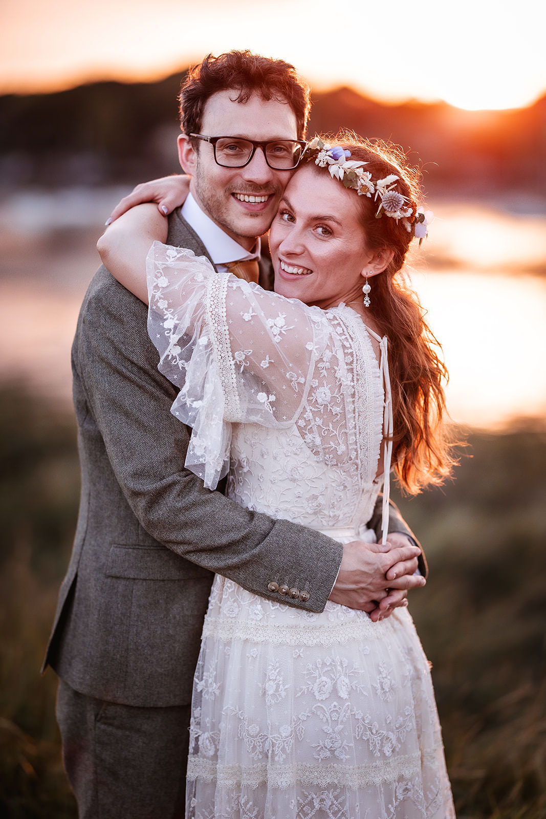 sunset photo of bride and groom cuddling each other at Warsash Harbour