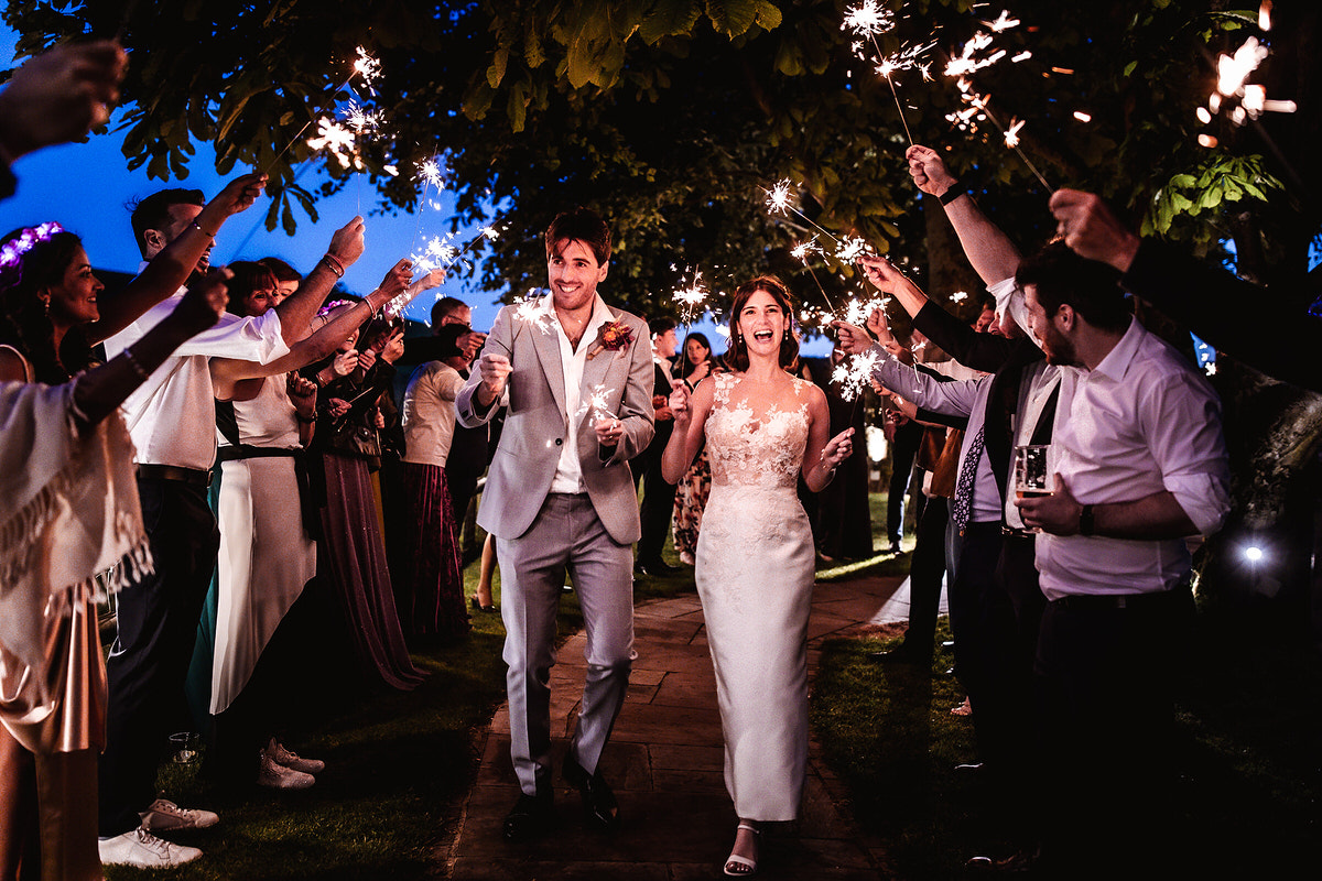 sparklers wedding photo of bride and groom running