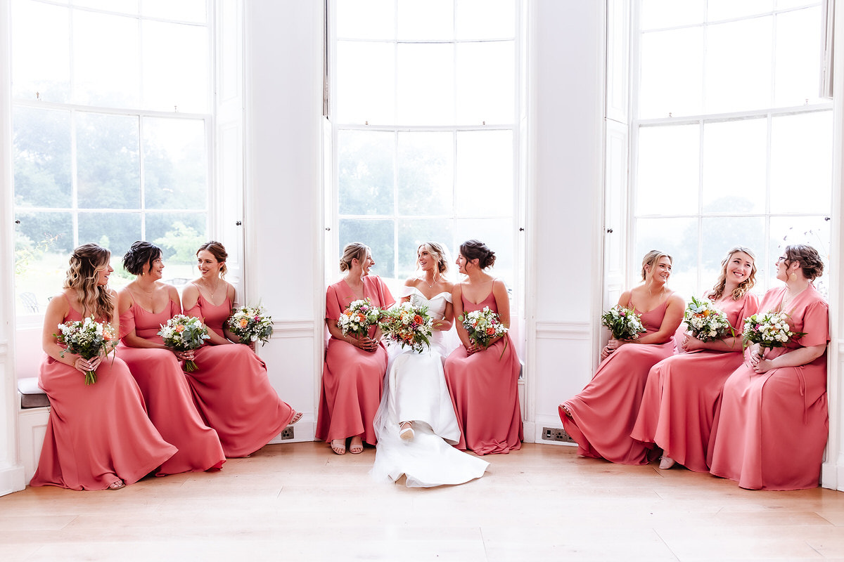 relaxed bridesmaid photos sitting with a bride by the window
