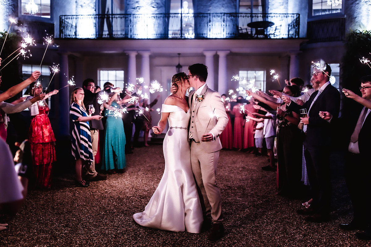 sparklers wedding photo of bride and groom kissing