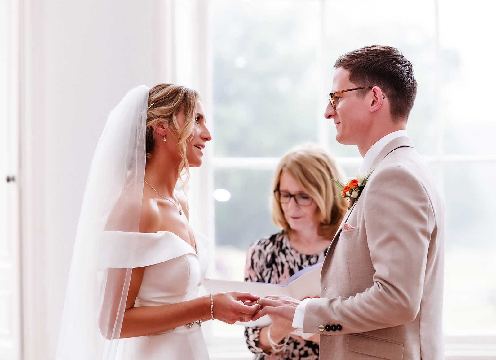 bride and groom looking at each other and holding their hands during the ceremony