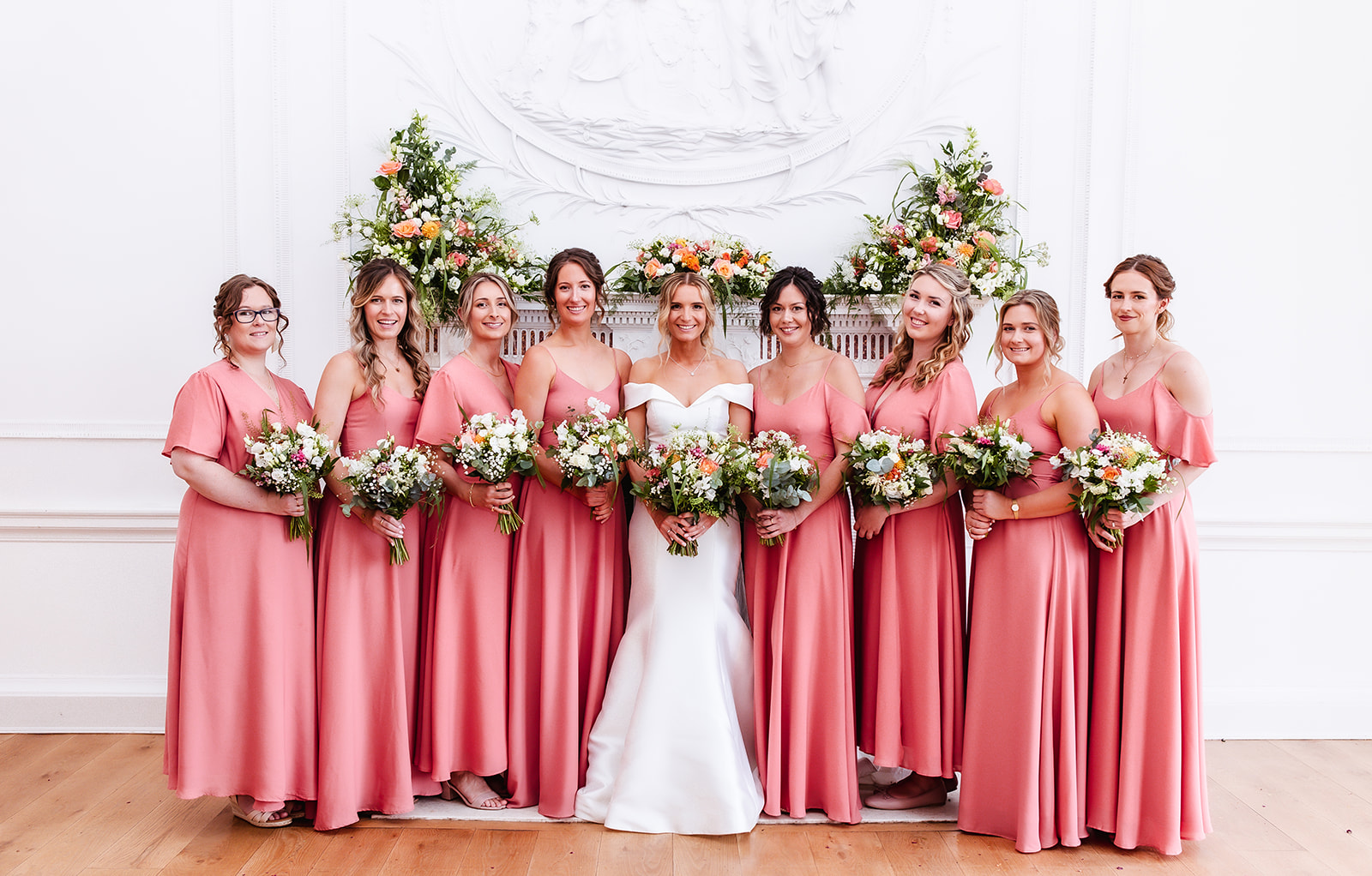 formal photo of bride and her bridesmaids holding the flowers