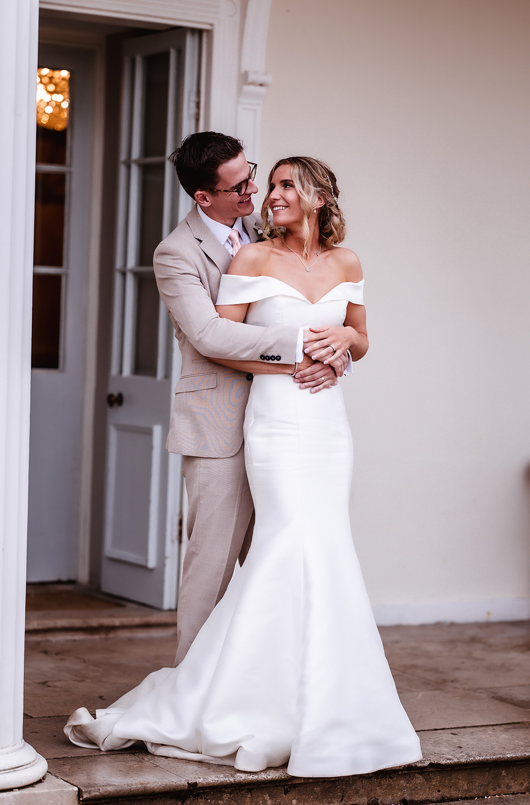 portrait of bride and groom cuddling and looking at each other