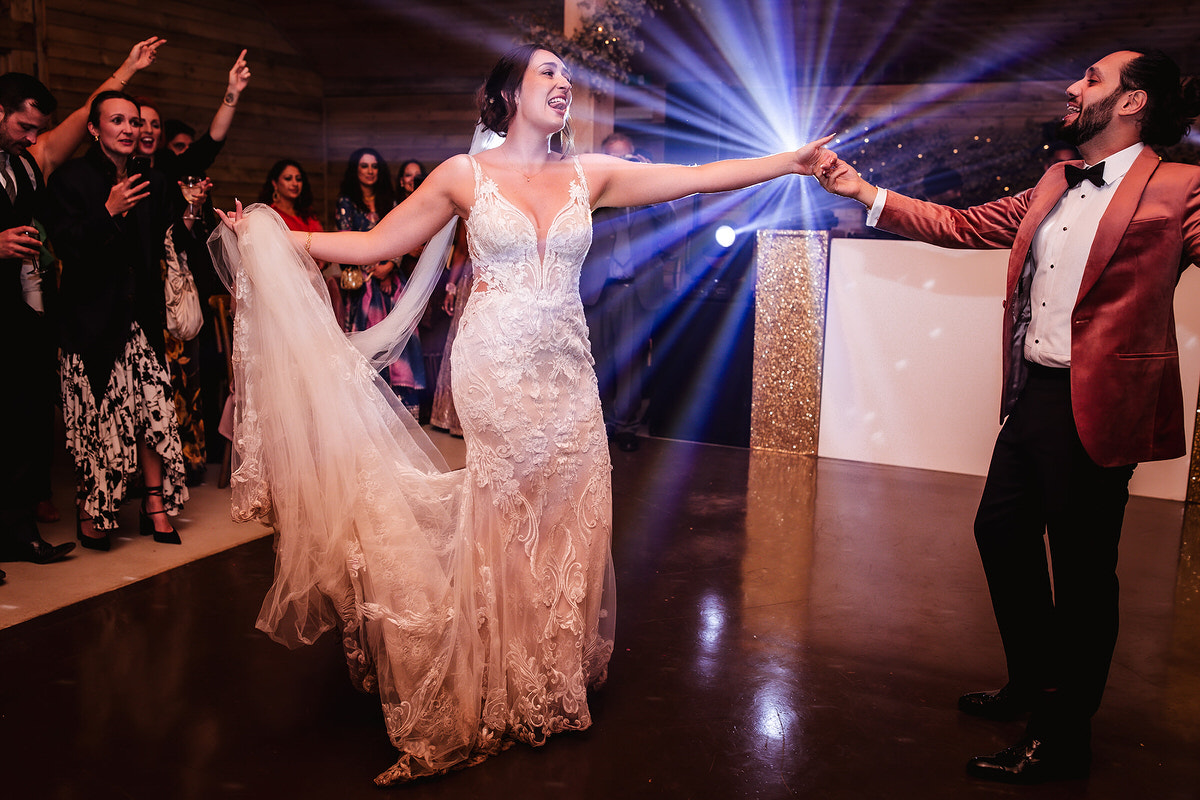 bride and groom's first dance at indoor country side barn in Surrey