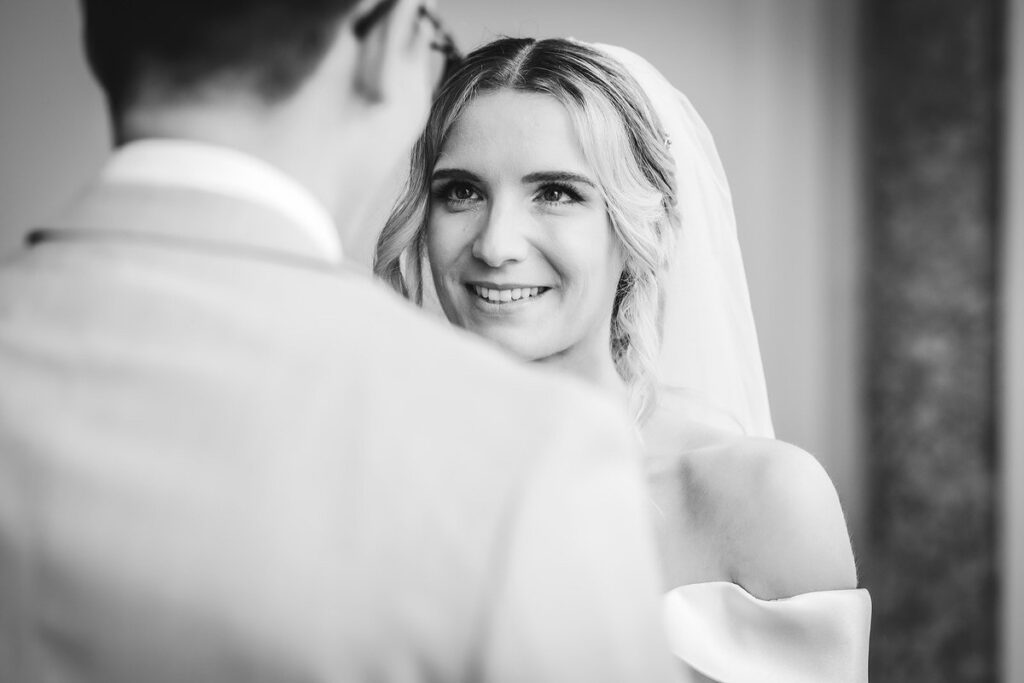 bride is looking at her groom during the wedding ceremony