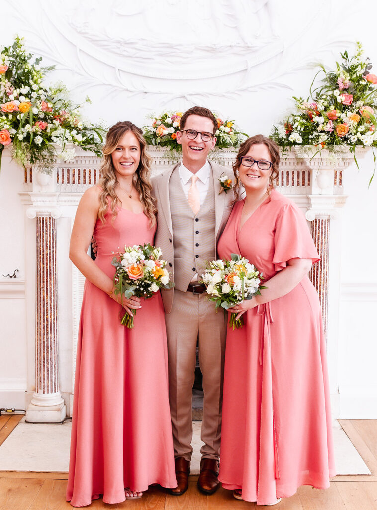 formal photo of groom and his sisters