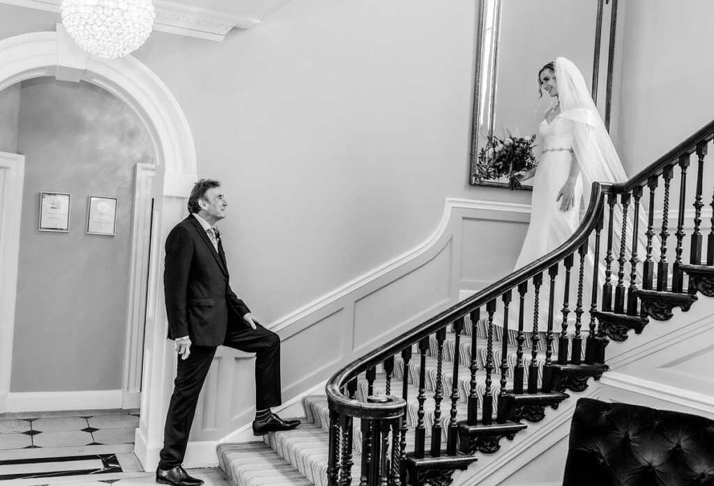 first look of father and bride by the stairs