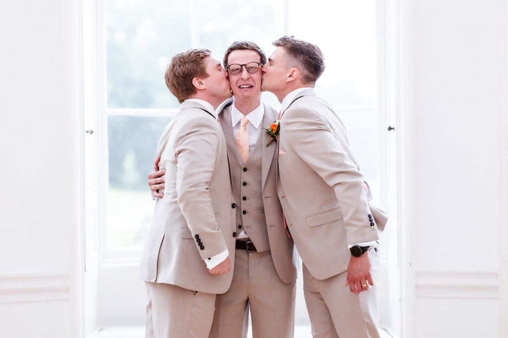 funny photo of groomsmen kissing the groom