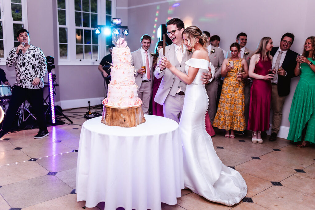 bride and groom cutting their three store wedding cake