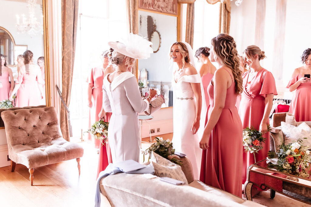 candid photo of bride and her bridesmaids and mum getting ready