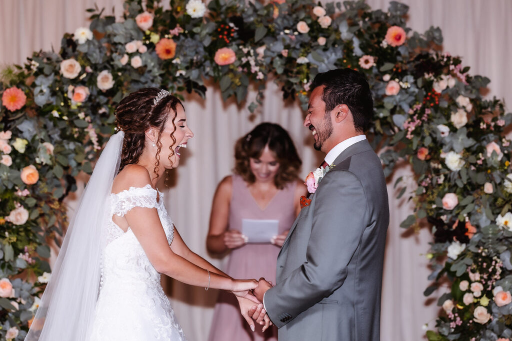 fun photo of bride and groom laughing at wedding ceremony