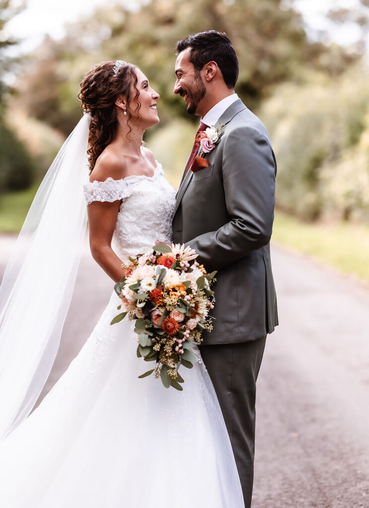 natural wedding photo of bride and groom looking at each other