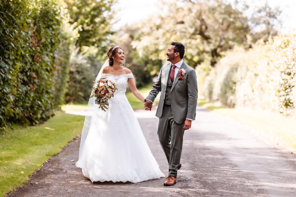 candid photo of bride and groom walking in the road and having a fun and chat