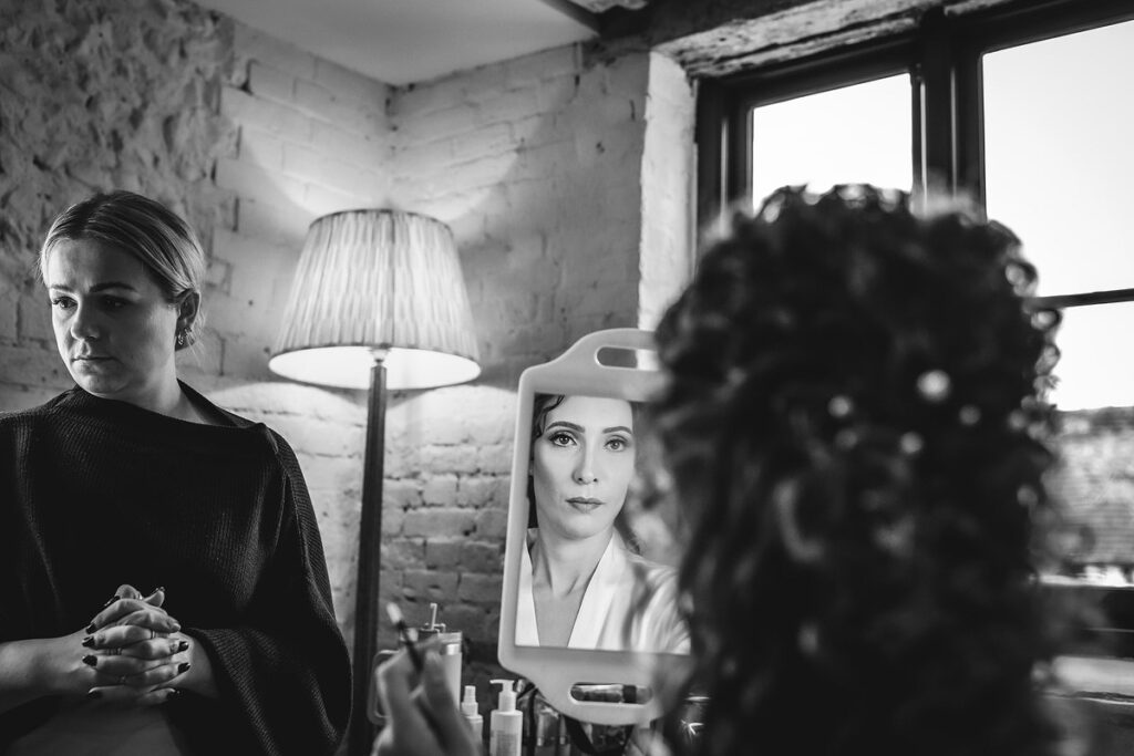 bride is getting ready and looking in the mirror