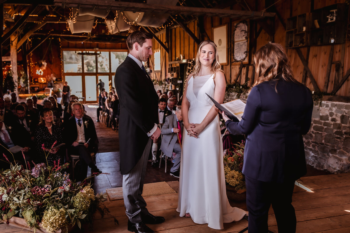 Wedding couple photo at indoor ceremony in Bowerchalke Barn