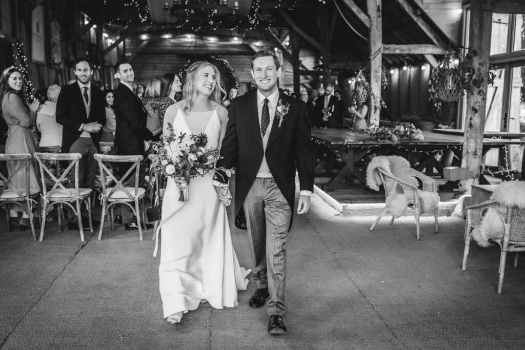 Indoor wedding ceremony at rustic barn in Wiltshire 