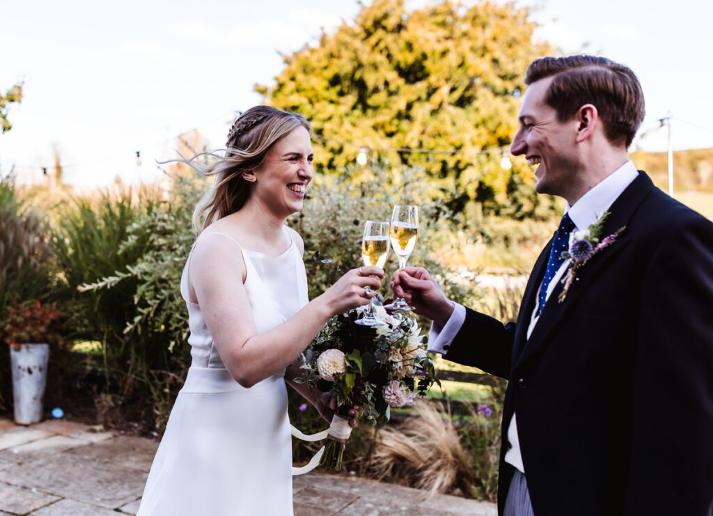 bride and groom after their ceremony drinking champagne 