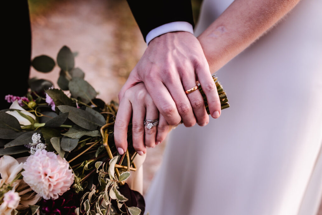 details of wedding rings with wedding flowers and bouquets 