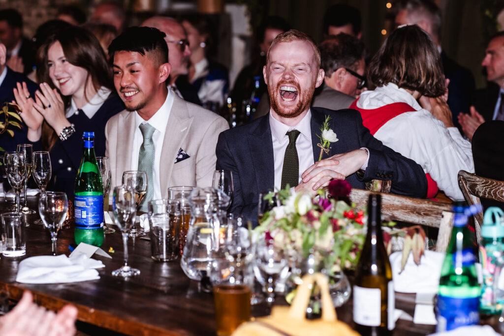 candid photos of guests having fun during the wedding speech