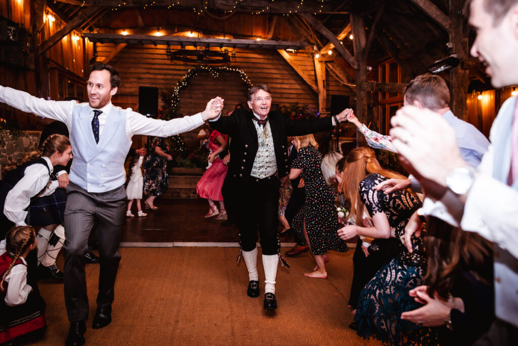 fun and relaxed photos of Ceilidh dance at the wedding