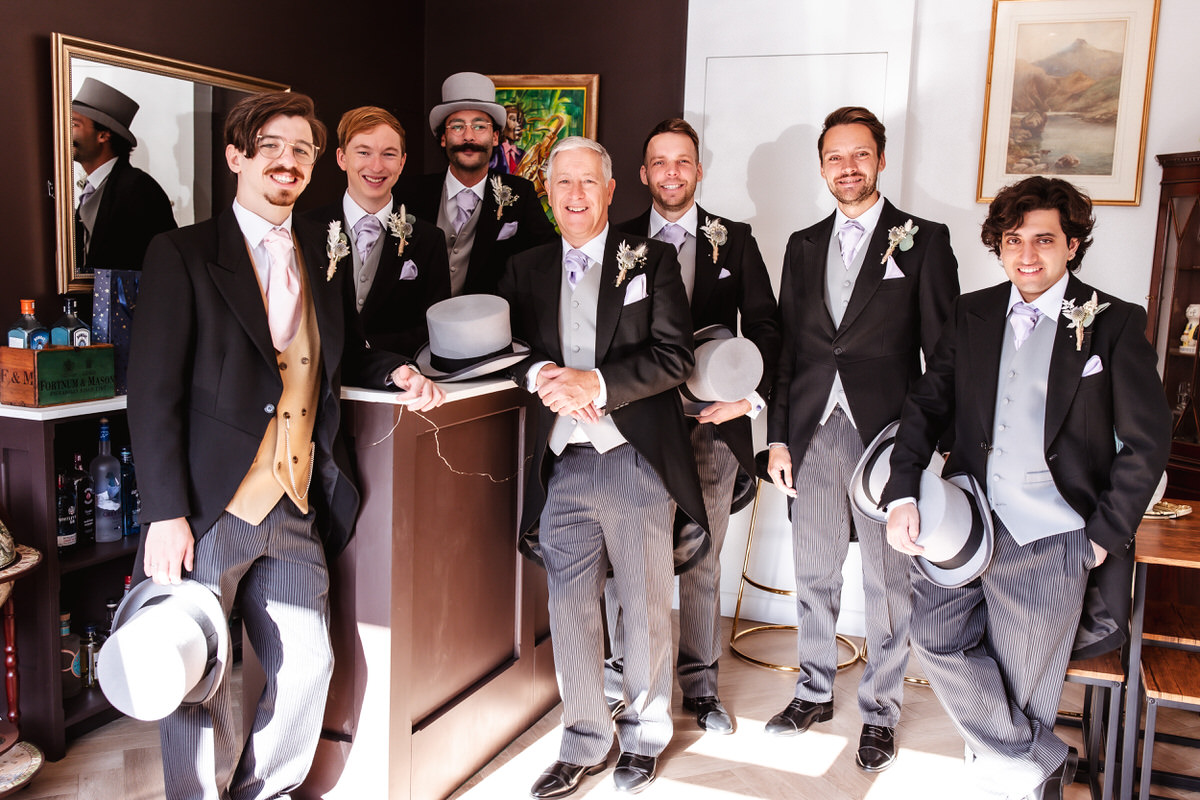 groom is getting ready with his father and groomsmen