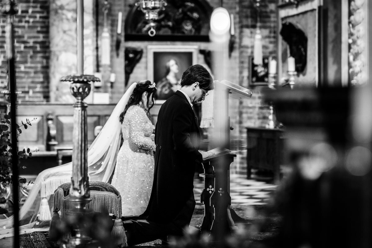 bride and groom are praying at their wedding church ceremony in Portsmouth, Hampshire