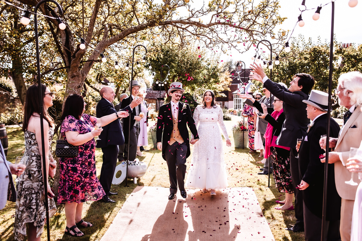 outdoor confetti photo of bride and groom in the garden