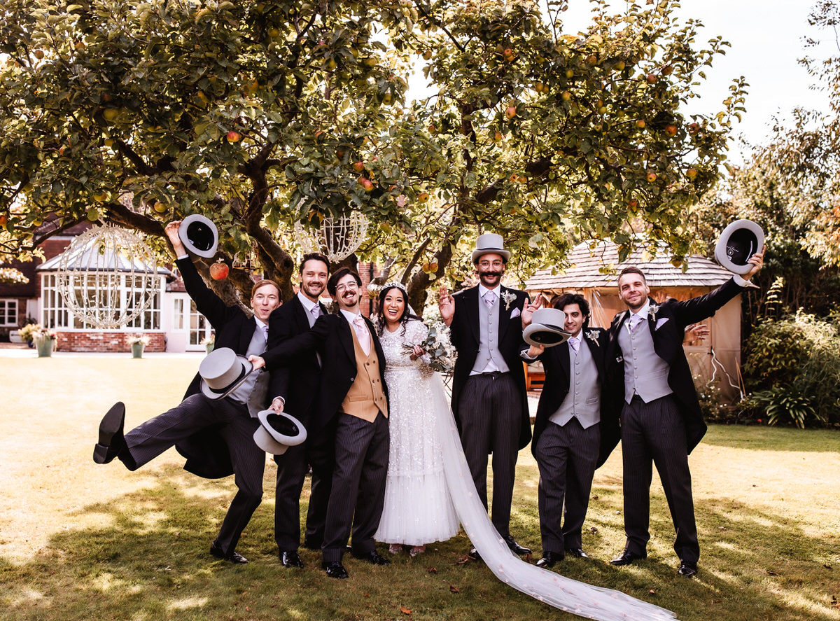 fun photo of bride and groom with their groomsmen and bridesmaids