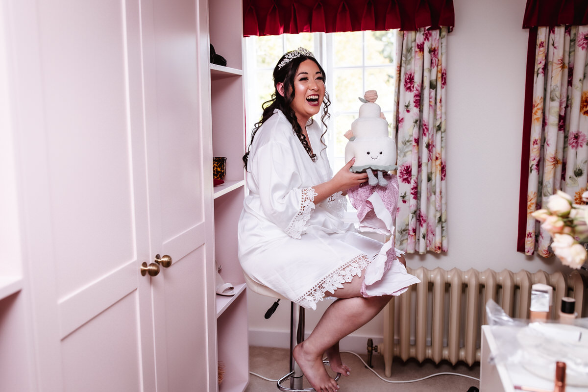 bride is getting ready and opening her gifts from her bridesmaids